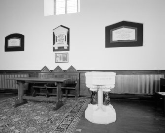 Interior.Platform details of communion table, memorials and font.