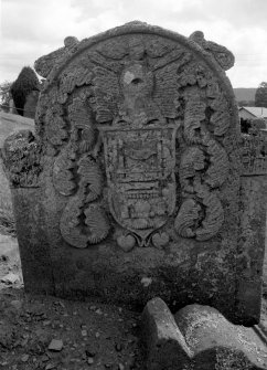 View of headstone, reverse side, commemorating John Doig (died 1780) with shield and tools of trade for Weavers.