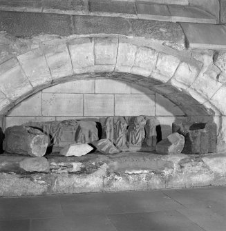 Interior. Collection of carved stone fragments in archway on S wall of ante-chapel