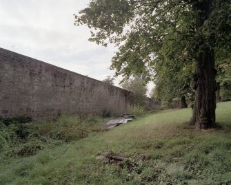 E House. Walled garden. S Wall. View from E.