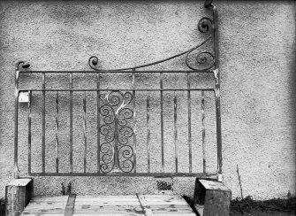 View of unmounted wrought iron gate against wall possibly at Robert Burns Cottage Museum, Ayr.