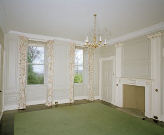 Interior. Ground floor View of drawing room from SEshowing 18th century paneling, giant pilasters and early 19th century fireplace