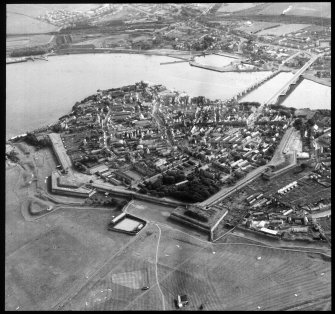 Aerial view showing town, walls and river.