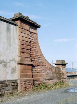 View from South-East of curtain wall on East side of station with ornate red sandstone portion at North end.