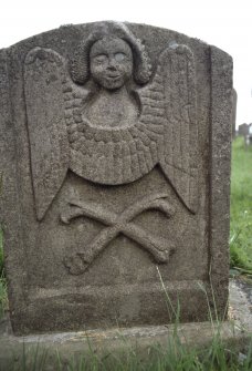 View of headstone showing angel over crossbones, Castleton Churchyard