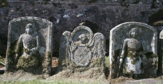 General view of gravestones against wall, Castleton Churchyard
