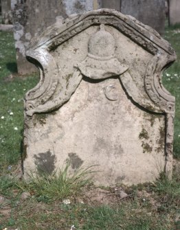 View of headstone showing helmet and dated 1735,  Longformacus Churchyard.