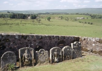 General view of gravestones against wall, Castleton Churchyard