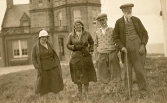 Scanned image of photograph of John Nicolson with a man and two women outside John O'Groats House