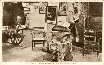 Scanned image of photograph entitled 'The Famous Old Blacksmith's Shop, Gretna Green, showing Priest with Marriage Register'