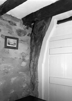 Interior view of cruck-framed cottage showing detail of east cruck in south wall; Wester Auchraw Croft, Lochearnhead.