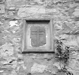 View of cross mounted on wall of Corrimony House. The cross is said to be from the former chapel of the Knights Templar (NH53SW2) and has since been moved to St Ninian's Church.