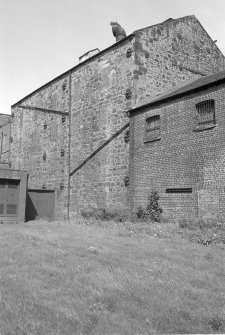 Stone warehouse with bricked-up windows.