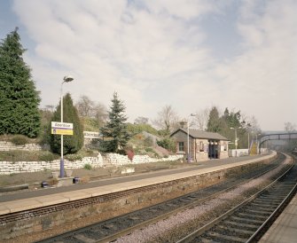 View from SW of N-bound platform, including waiting room and shelter, and station garden