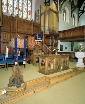 Interior. Platform area with pulpit, lecturn, communion table and organ