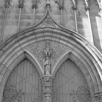 Detail. Entrance door spandrel with female saint