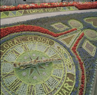 View of floral clock and 'Tempus Fugit' floral border from south west