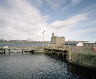 View from SSW showing entrance to the Dry Dock with transit sheds 26, 27 and the Harbour Warehouse in the background.
