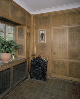 Interior. View of panelled entrance hall with fireback umbrella stand