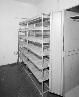 Interior view of armoury/main camp store, showing former cell
