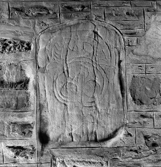 General view of Tocherford Pictish stone bearing an unusually curved variant of the horse-shoe symbol above a disc enclosing three smaller circles.