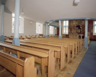 Interior. View from S showing gallery columns and pews