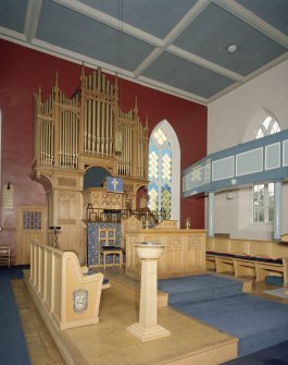 Interior. View ofplatform showing organ, communion table, font and eler's seats