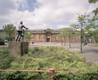 View from E showing entrance with statue to left