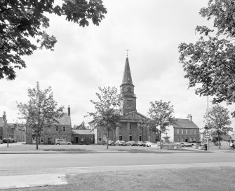 General view from ENE showing town square with town house and manse