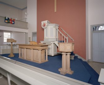 Interior. Ground floor. Pulpit, font and communion table.