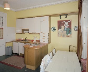 Interior. First floor. Private or family kitchen with 1970's units showing dining area and portrait of Ninian Brodie of Brodie