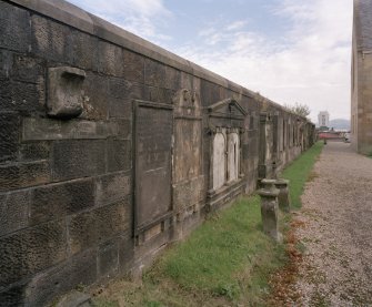 Churchyard wall detail of historic re-sited grave stones