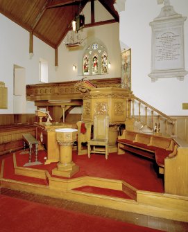 Interior. Platform area showing pulpit, font and communion table