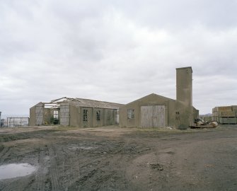 View NW of two brick and concrete huts on the western side of the camp.