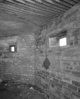 Interior view of type 27 pillbox showing metal plate on chain used to plug gun loop when not in use.
