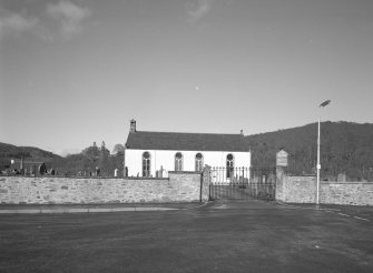 View from S showing graveyard wall and main gates