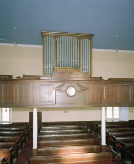 Interior. Detail of organ, clock, gallery front and columns