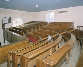 Interior. Detail of curved gallery pews