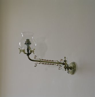 Interior. Detail of wall mounted brass gas lamp