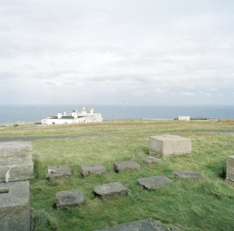 View from S of group of mast bases at the N end of the transmitter receiver block. Also visible is the Dunnet Lighthouse keeper's cottage.