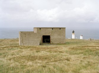 View from SE of engine room with blast wall. Also visible is Dunnet head lighthouse.