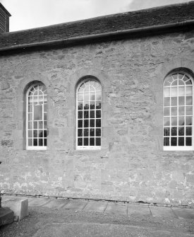 Detail of arched windows and stonework including blocked doorway