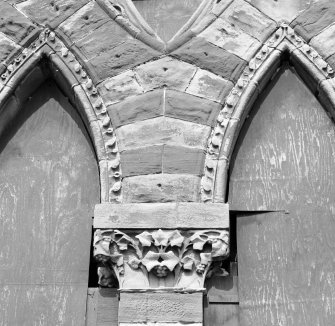 Detail of folited carved capital and arches