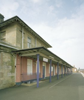 Detailed view from S along N-bound platform showing awning in front of station offices