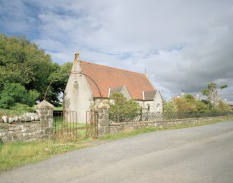 View from SSW showing stting with walls, railings and gates