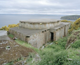 View from N showing the rear elevation and roof of eastern World War II 6-inch gun-emplacement.  Also visible is the rear entrance and the remains of a camouflage pattern.