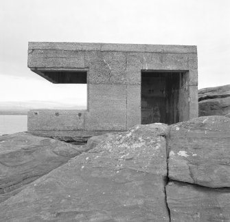 View from NW of searchlight emplacement showing entrance and foundation on bedrock