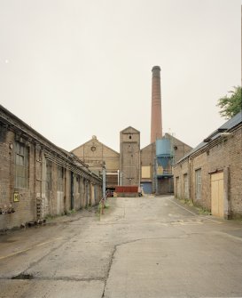 View from SSE showing paper mill (left), 'clay building (right), and boilerhouse and chimney (centre)