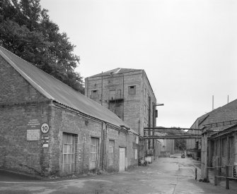 View from NNW of electricians' workshop (foreground left), 'clay building' (centre left) and ball mill (distant left), with part of main paper mill visible to right