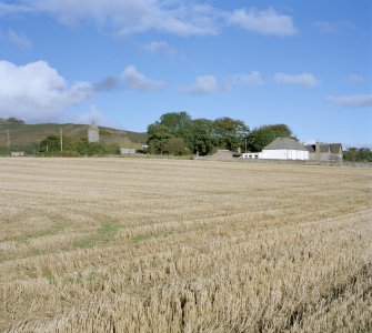 Distant view from S showing church and school.